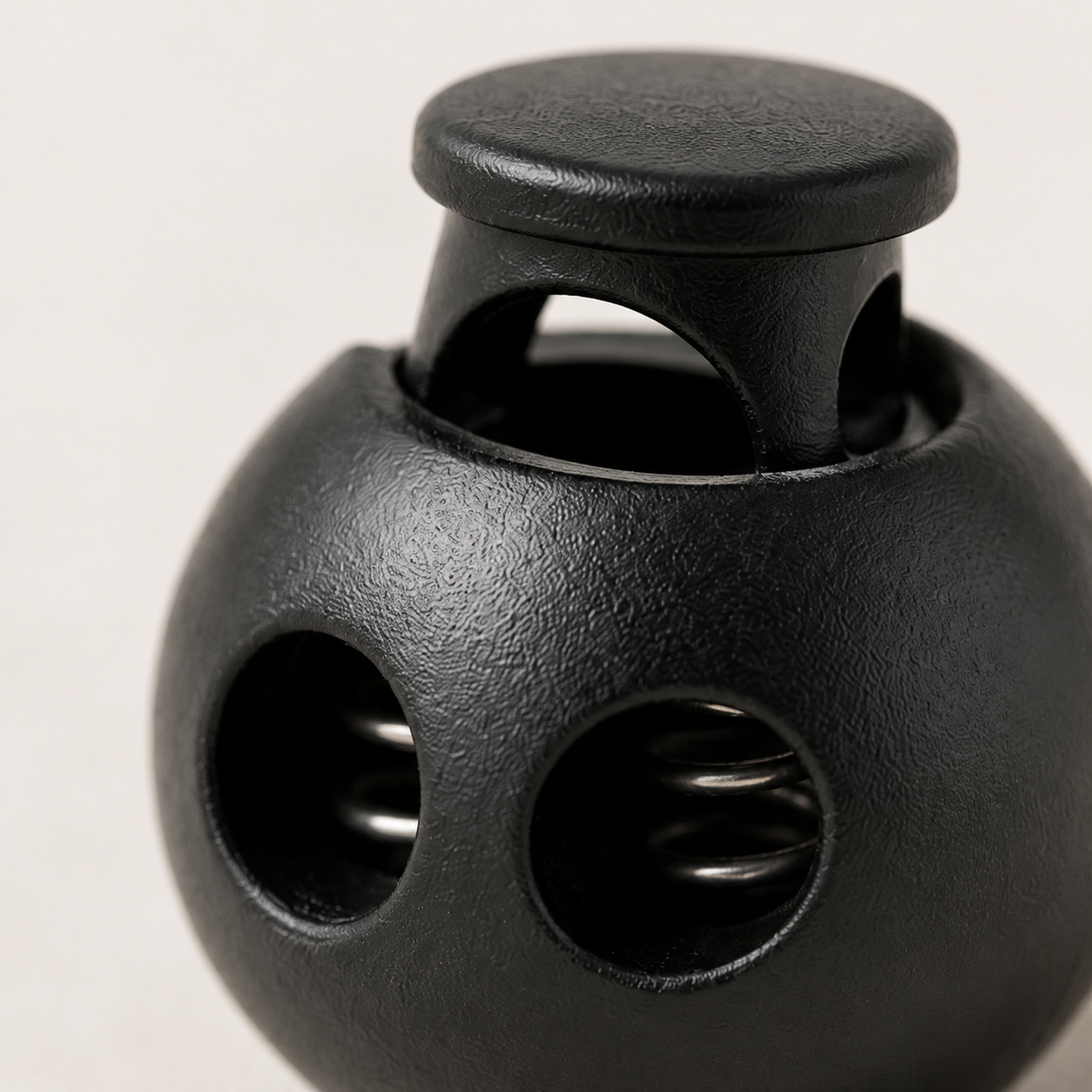 bomb shaped black cord stopper, macro view